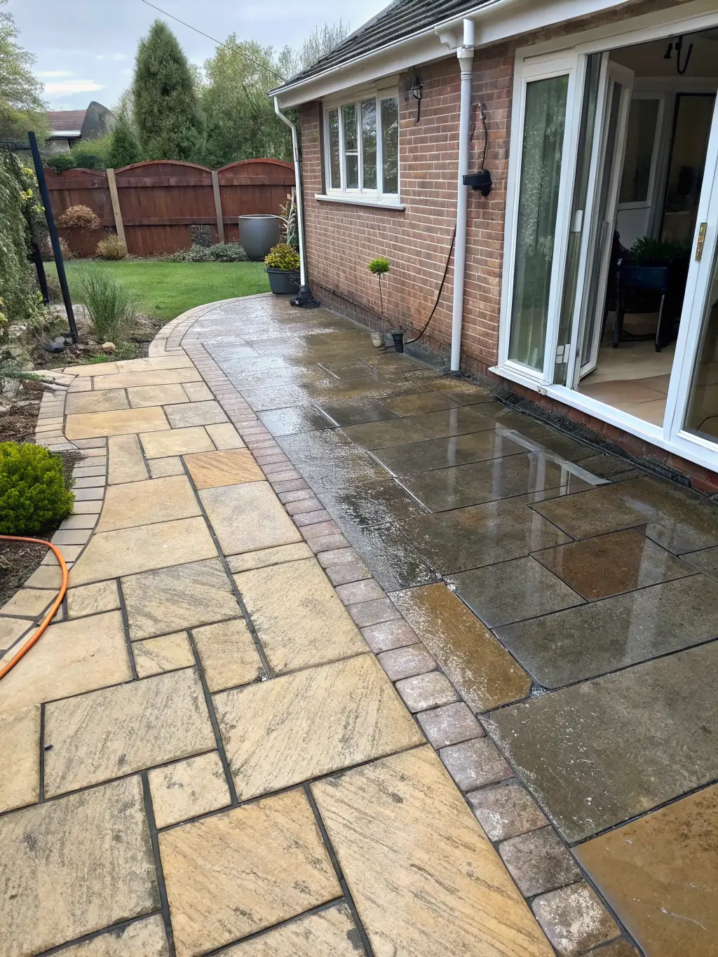 A before-and-after shot of a patio, showcasing the transformative power of power washing services.